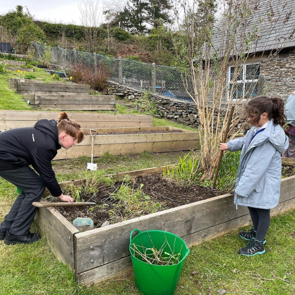 Two children working on a raised bed