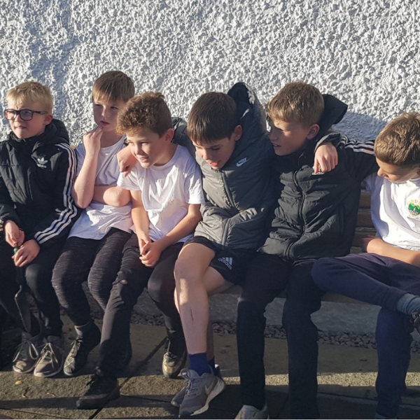 A group of children sitting together on a bench in Staveley.